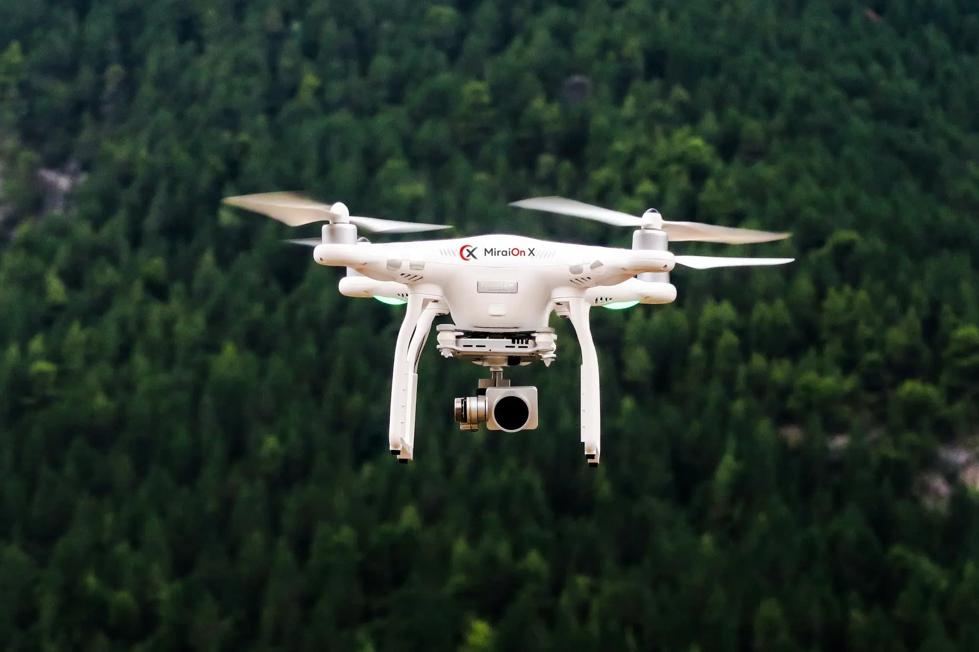 MiraiOn X HiveGrid survey drone in flight over dense forest canopy